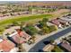 Aerial view of a house situated near a golf course and residential area at 2596 E Desert Wind Dr, Casa Grande, AZ 85194