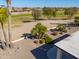 Landscaped backyard with partial view of golf course at 2596 E Desert Wind Dr, Casa Grande, AZ 85194