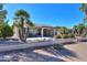 Landscaped backyard with covered patio and view of golf course at 2596 E Desert Wind Dr, Casa Grande, AZ 85194