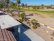 Covered patio and beautifully landscaped backyard with golf course view at 2596 E Desert Wind Dr, Casa Grande, AZ 85194