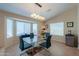 Elegant dining room with a glass table and modern chandelier at 2596 E Desert Wind Dr, Casa Grande, AZ 85194