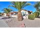 Tan house with brown garage door and rock landscaping at 2596 E Desert Wind Dr, Casa Grande, AZ 85194