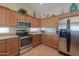 Inviting kitchen with wood cabinets and updated appliances at 2596 E Desert Wind Dr, Casa Grande, AZ 85194