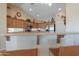 Open kitchen with breakfast bar and stainless steel appliances at 2596 E Desert Wind Dr, Casa Grande, AZ 85194