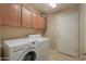 Laundry room with washer, dryer and upper cabinets at 2596 E Desert Wind Dr, Casa Grande, AZ 85194