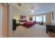 Main bedroom with king bed, sitting area, and bay window at 2596 E Desert Wind Dr, Casa Grande, AZ 85194