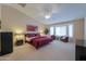 Bright main bedroom with a king-size bed and sitting area at 2596 E Desert Wind Dr, Casa Grande, AZ 85194