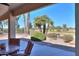 Covered patio with golf course view and seating area at 2596 E Desert Wind Dr, Casa Grande, AZ 85194
