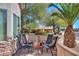 Small patio with fire pit and four black chairs at 2596 E Desert Wind Dr, Casa Grande, AZ 85194
