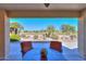 Covered patio with golf course view and seating area at 2596 E Desert Wind Dr, Casa Grande, AZ 85194