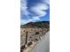View of a modern house on a hillside with a paved driveway and chain link fence at 2809 E Frye Rd, Phoenix, AZ 85048
