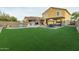 Expansive backyard with a pool, patio, and artificial turf at 4446 W Hower Rd, Phoenix, AZ 85086