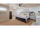 Large main bedroom with ceiling fan, wood-like accent wall, and en-suite bathroom at 4446 W Hower Rd, Phoenix, AZ 85086