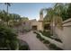Landscaped backyard with patio, seating area, and mature palm trees at 4710 N 65Th St, Scottsdale, AZ 85251