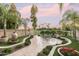 Landscaped backyard with patio, seating area, and mature palm trees at 4710 N 65Th St, Scottsdale, AZ 85251