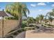 Landscaped backyard with patio, seating area, and mature palm trees at 4710 N 65Th St, Scottsdale, AZ 85251