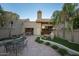 Landscaped backyard with patio, seating area, and mature palm trees at 4710 N 65Th St, Scottsdale, AZ 85251