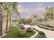 Landscaped backyard with patio, seating area, and mature palm trees at 4710 N 65Th St, Scottsdale, AZ 85251