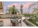 Landscaped backyard with patio, seating area, and mature palm trees at 4710 N 65Th St, Scottsdale, AZ 85251