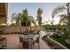 Landscaped backyard with patio, seating area, and mature palm trees at 4710 N 65Th St, Scottsdale, AZ 85251
