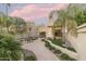 Landscaped backyard with patio, seating area, and mature palm trees at 4710 N 65Th St, Scottsdale, AZ 85251