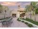 Landscaped backyard with patio, seating area, and mature palm trees at 4710 N 65Th St, Scottsdale, AZ 85251