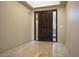 Bright entryway with tile flooring and elegant dark wood door at 4710 N 65Th St, Scottsdale, AZ 85251