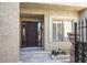 Elegant entryway featuring a dark wood door and a stone pathway at 4710 N 65Th St, Scottsdale, AZ 85251