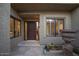 Inviting entryway with a rich wood door, stone flooring, and decorative accents at 4710 N 65Th St, Scottsdale, AZ 85251