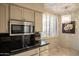Kitchen with stainless steel appliances and a chic chandelier at 4710 N 65Th St, Scottsdale, AZ 85251