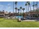 Community pool area with lush landscaping, a gazebo, and lounge chairs at 4710 N 65Th St, Scottsdale, AZ 85251