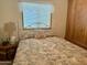 Bright bedroom with a double bed, window with blinds, and built-in shelving at 7750 E Broadway Rd # 348, Mesa, AZ 85208
