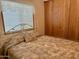 Spacious bedroom with double bed, window with blinds and mirrored closet doors at 7750 E Broadway Rd # 348, Mesa, AZ 85208