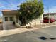 Single-wide manufactured home with carport and mature landscaping at 7750 E Broadway Rd # 348, Mesa, AZ 85208