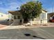 Single-wide manufactured home with carport and mature landscaping at 7750 E Broadway Rd # 348, Mesa, AZ 85208