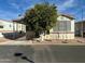 Single-wide manufactured home with covered porch and mature landscaping at 7750 E Broadway Rd # 348, Mesa, AZ 85208
