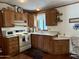 Efficient kitchen with ample wood cabinetry and built-in microwave at 7750 E Broadway Rd # 348, Mesa, AZ 85208