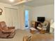 Living area with rocking chair and view into bathroom at 7750 E Broadway Rd # 348, Mesa, AZ 85208