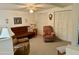 Cozy living room featuring a brown couch, armchair, and built-in shelving at 7750 E Broadway Rd # 348, Mesa, AZ 85208