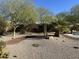 Landscaped backyard with gravel, desert plants, and a glimpse of the pool at 12721 S 177Th Ave, Goodyear, AZ 85338