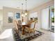 Elegant dining area with chandelier and hardwood table at 16907 W Greenbriar Point Ct, Surprise, AZ 85387