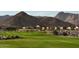 Green golf course with mountain backdrop and homes in the background at 20305 W Turney Ave, Buckeye, AZ 85396