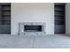 Modern fireplace with granite surround and built in shelving at 37200 N Cave Creek Rd # 1023, Scottsdale, AZ 85262