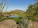 Scenic golf course with a pond and mountain views at 37200 N Cave Creek Rd # 1023, Scottsdale, AZ 85262