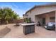 Spacious backyard with a fire pit, patio, and outdoor kitchen at 44032 W Garden Ln, Maricopa, AZ 85139