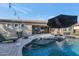 Inviting backyard oasis with a sparkling pool and patio at 4521 N 152Nd Dr, Goodyear, AZ 85395