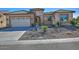 One-story home with tile roof, desert landscaping, and a two-car garage at 7387 W Cactus Wren W Way, Florence, AZ 85132