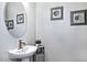 Stylish powder room with oval mirror and pedestal sink at 7387 W Cactus Wren W Way, Florence, AZ 85132