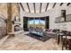 Living area with stone fireplace, large windows, and a built-in bar with seating at 7552 E Whisper Rock Trl, Scottsdale, AZ 85266