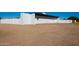 Rear view of a remodeled home with white exterior and gravel driveway at 9195 N Diffin Rd, Florence, AZ 85132